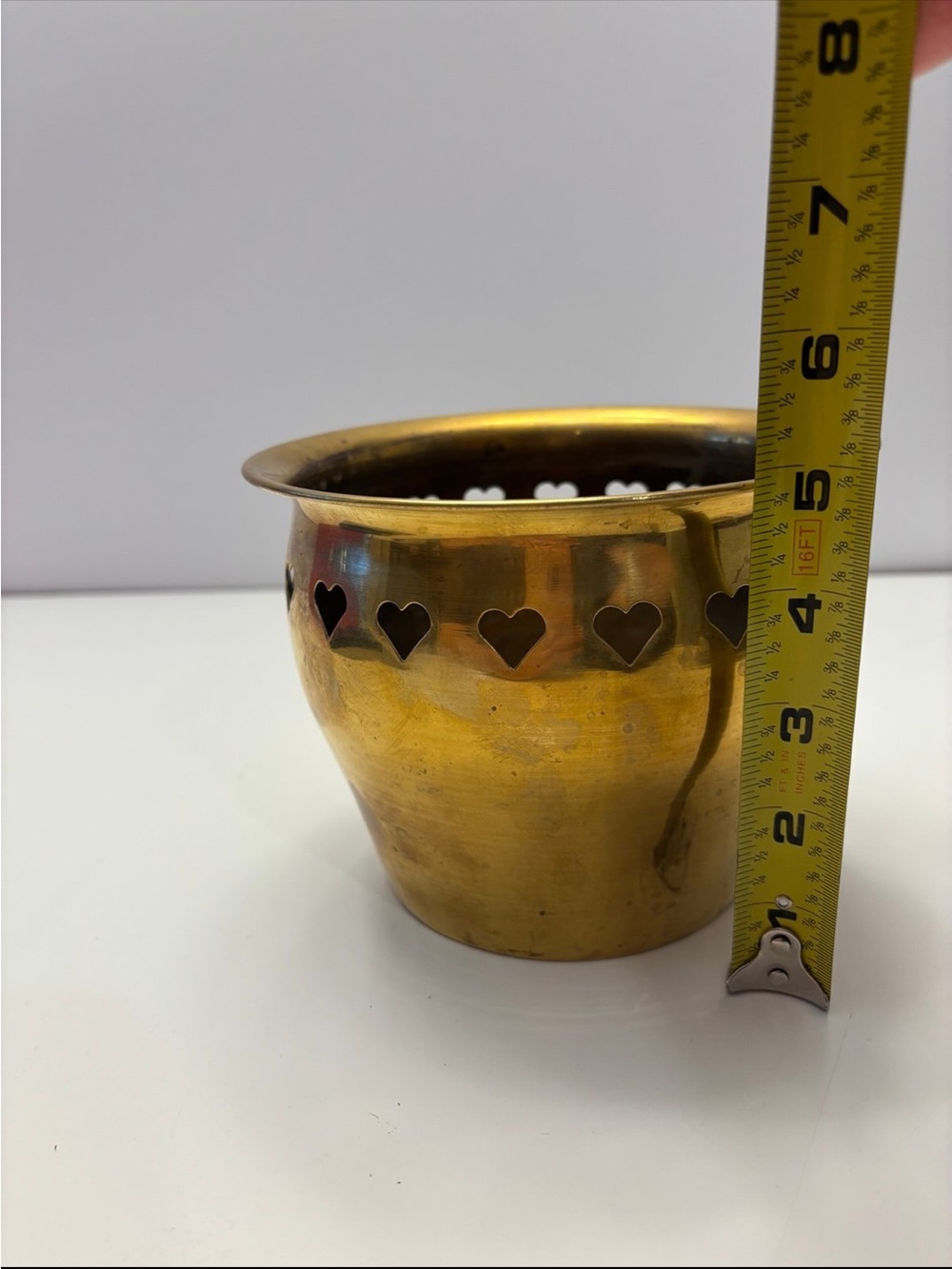 Vintage brass planter with heart-shaped cutouts along the top rim